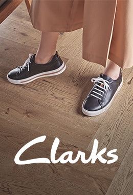Woman stood on wooden flooring, wearing a pair of Clarks Un Maui shoes
