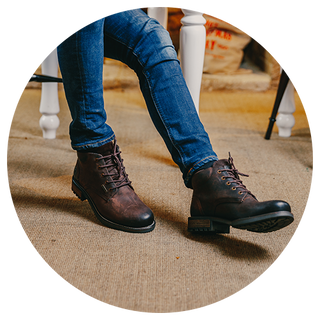 Close up of a man wearing a pair of brown Cotswold boots