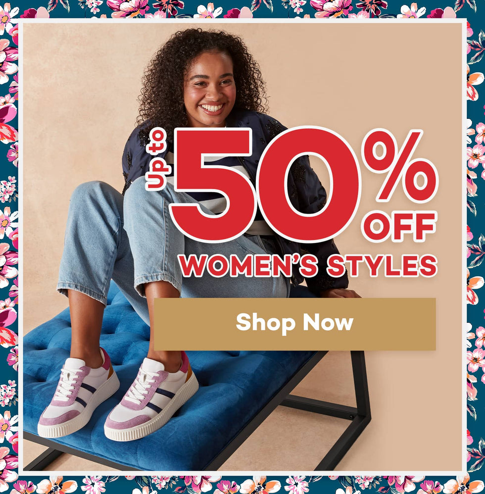 Promotional image with a woman sitting on a blue chair, featuring up to 50% off discount on women's styles. Click to shop now.